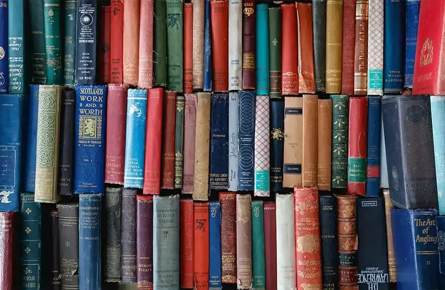 A stack of books of all shapes and colors.